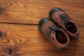 Leather kids boots on a wooden background top view with copy space Royalty Free Stock Photo