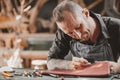 Leather maker artist handcraft working at own workshop small studio made by order masterwork piece Royalty Free Stock Photo