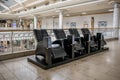 Leather massage chairs in a row inside a modern shopping centre mall