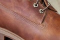 Brown waterproof leather mens boots stitched with thread. Close up view Royalty Free Stock Photo