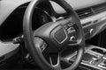 Leather multifunction steering wheel in the cabin of a premium car. Installed under the steering wheel control switches additional Royalty Free Stock Photo