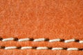 Leather is natural orange, seam is made of white threads, close-up macro view Royalty Free Stock Photo