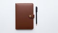 Leather notebook with a buttoned strap closure placed on a white Royalty Free Stock Photo
