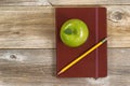 Leather notepad with apple and pencil for school or office on ru Royalty Free Stock Photo