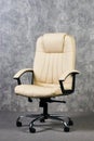 Leather office chair in empty room with gray texture wall background Royalty Free Stock Photo