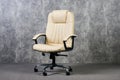 Leather office chair in empty room with gray texture wall background Royalty Free Stock Photo