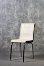 Leather office chair in empty room with gray texture wall background Royalty Free Stock Photo