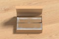 Leather opened rectangle folding gift box mock up with silver wrapping paper on wooden background. Front view