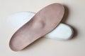 Leather orthopedic insoles for footwear on beige background