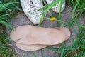 Leather orthopedic insoles with running shoes on the grass. Heal