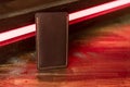 Leather phone case on a wooden background in neon light Royalty Free Stock Photo
