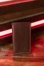 Leather phone case on a wooden background in neon light Royalty Free Stock Photo