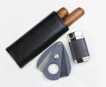 Leather pouch with two Cuban cigars, cutter and lighter