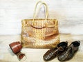 Leather products: bags, shoes, belts on a wooden textured background Royalty Free Stock Photo