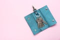 Leather ring holder with keys on pink background, top view. Space for text Royalty Free Stock Photo