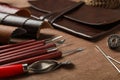 Leather samples and tools on brown table, closeup Royalty Free Stock Photo