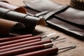 Leather samples and tools on brown table, closeup Royalty Free Stock Photo