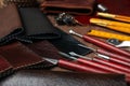 Leather samples and tools on brown table, closeup Royalty Free Stock Photo