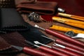 Leather samples and tools on brown table Royalty Free Stock Photo