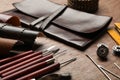 Leather samples and tools on brown table Royalty Free Stock Photo
