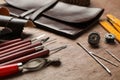 Leather samples and tools on brown table Royalty Free Stock Photo