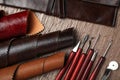 Leather samples and tools on brown table, flat lay Royalty Free Stock Photo