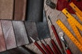 Leather samples and tools on brown table, flat lay Royalty Free Stock Photo
