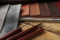 Leather samples and tools on wooden table, closeup Royalty Free Stock Photo