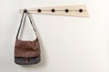 Satchel Hanging on a Wooden Wall Coat Rack