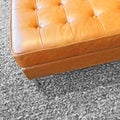 Leather seat on gray wool carpet