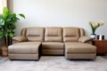 Leather sectional reclining sofa in family room in earthy green and brown tones