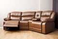 Leather sectional reclining sofa in family room in earthy green and brown tones