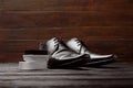 Leather shoes and cleaning sponge on dark table Royalty Free Stock Photo