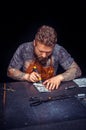 Professional Tanner creating leatherwork in his workshop