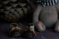 leather small shoes near the feets of teddy bear. the concept of light industry for the manufacture of stylish