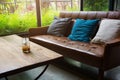 Leather sofa with a glass of water on a wooden table in a coffee Royalty Free Stock Photo