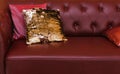 Leather sofa with shiny cushions. Quilted sofa wall. Luxury in the interior