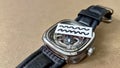 A leather strap watch topped with an image of ripples depicting an idiom about wrinkles in time. Royalty Free Stock Photo