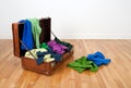 Leather suitcase full of colorful clothing Royalty Free Stock Photo