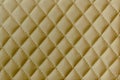 Leather texture background. Yellow leather stitched with threads