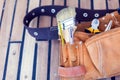 Leather tool belt with construction tooling on the wooden board. Maintenance concept Royalty Free Stock Photo