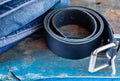 Leather trousers belt and jeans. Comfortable pants. Work clothes. Blue material and boards. Royalty Free Stock Photo