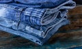 Blue jeans. Comfortable pants. Work clothes. Blue material and boards. Old boards Metal belt buckle. Folded pants. Royalty Free Stock Photo