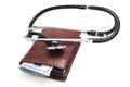 A leather wallet being examined with a stethoscope Royalty Free Stock Photo