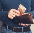 Leather wallet with money in male hands. Purse with roubles in male hands