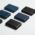 Leather wallets in two colors, blue and black, are arranged in a staggered pattern. The Royalty Free Stock Photo