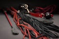 Leather whip flogger sex toys on a dark background stock photo images