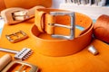 Leather working or Leather craft. Orange tanned leather on leather craftman`s work desk . Working tools on a work table Royalty Free Stock Photo