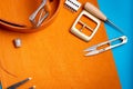 Leather working or Leather craft. Orange tanned leather on leather craftman`s work desk . Working tools on a work table Royalty Free Stock Photo