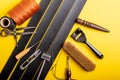 Leather working or Leather craft. Black tanned leather on leather craftman`s work desk . Working tools on a work table Royalty Free Stock Photo